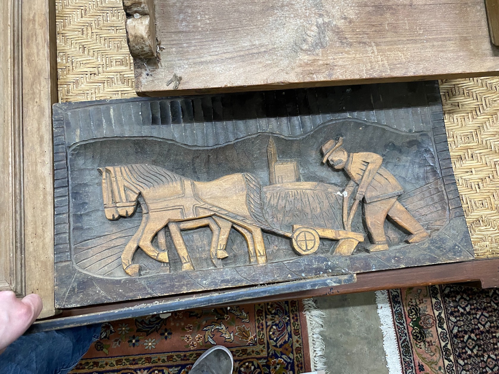 An Asian hardwood low seat, a relief carved panel, a lion's mask carved door and a cast iron grate